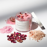 Open jar of Amaraa Relax + Unwind rose bath salt with pink crystals and dried rose petals